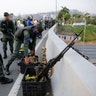 Soldiers take a position on an overpass next to La Carlota air base in Caracas, April 30, 2019. Venezuelan opposition leader Juan Guaido has called for a military uprising, in a video shot at the air base showing him surrounded by soldiers and accompanied by detained activist Leopoldo Lopez.