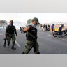 An uprising member of the Bolivarian National Guard gestures outside La Carlota air base in Caracas, Tuesday, April 30, 2019.?
