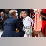 Britain's Prince Harry, the Duke of Sussex is presented with a posey by Zofia Zdenkowska, as he attends the Lord Mayor's Big Curry at the Guildhall, London, April 4, 2019. 