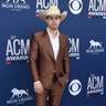 Dustin Lynch looks dapper in an all brown suit with matching gold snakeskin boots.