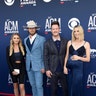 Florida Georgia Line's Brian Kelley with wife Brittney Marie Cole and Tyler Hubbard with wife Hayley Stommell all color coordinate in navy blue outfits.