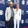 Jason Aldean and Brittany Kerr Aldean color coordinate in white outfits.
