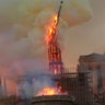 Flames and smoke rise as the spire of Notre Dame Cathedral collapses.