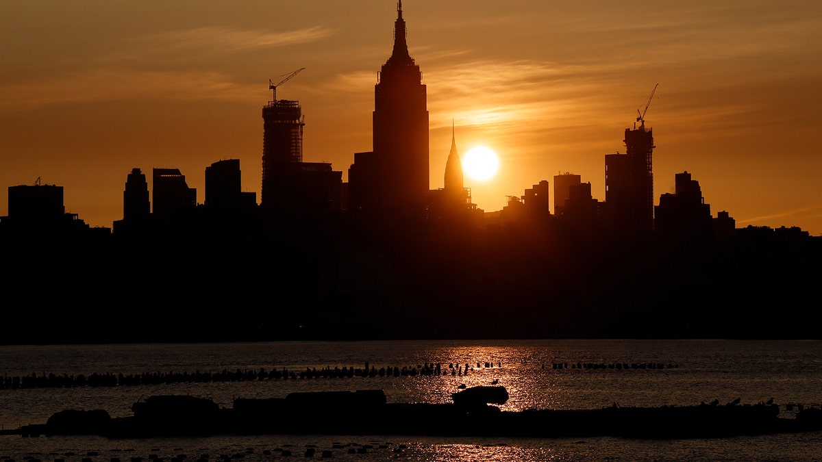 JERSEY CITY, NJ - MAY 25: The sun rises behind the Empire State Building, Chrysler Building and One Vanderbilt in New York City on May 25, 2019, as seen from Jersey City, New Jersey. (Photo by Gary Hershorn/Getty Images)