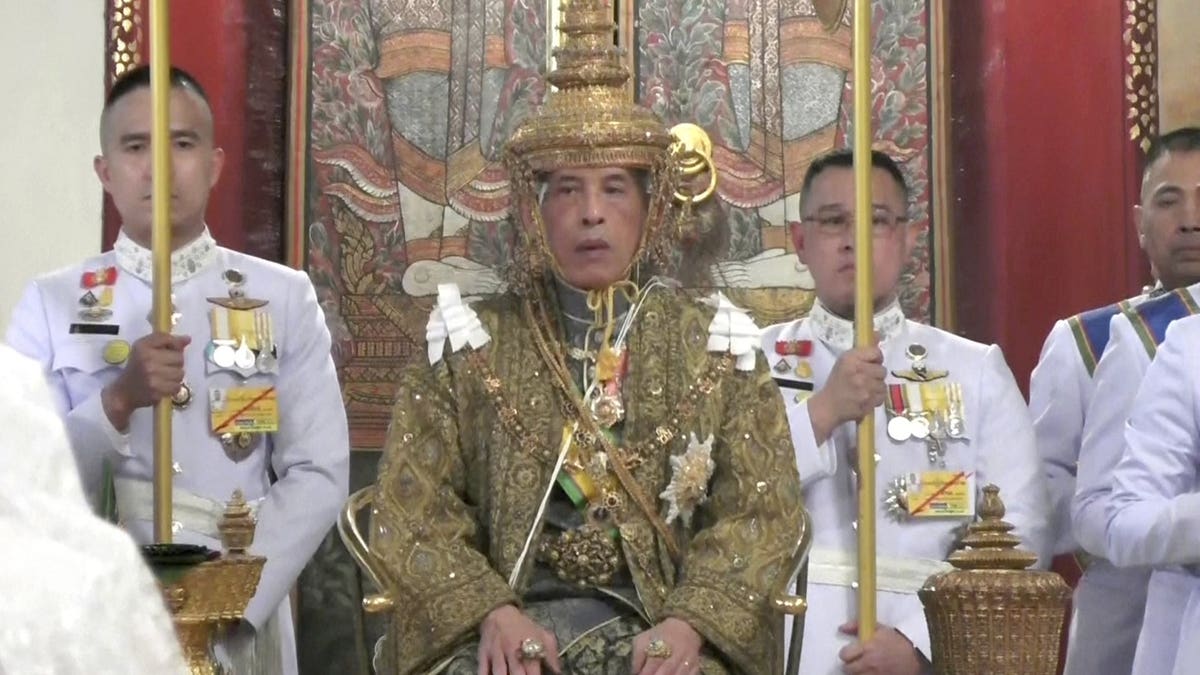 In this image made from the video, Thailand’s King Maha Vajiralongkorn, center, sits on the throne as he is officially crowned king at the Grand Palace, Saturday, May 4, 2019, in Bangkok, Thailand. Saturday began three days of elaborate centuries-old ceremonies for the formal coronation of Vajiralongkorn.