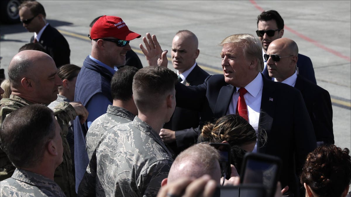 President Donald Trump greets troops after landing at Joint Base Elmendorf-Richardson for a refueling stop en route to Japan Friday, May 24, 2019, in Anchorage. (Associated Press)