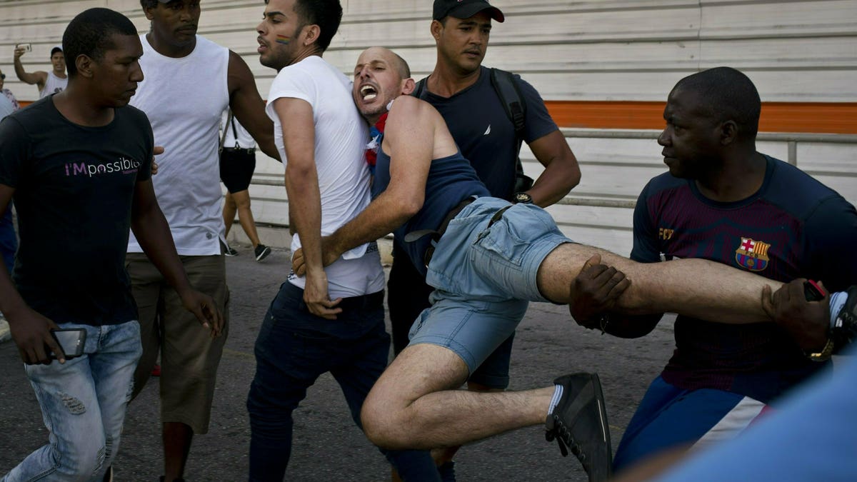 Cuban police detain a gay rights activist taking part in an unauthorized march in Havana, Cuba, Saturday, May 11, 2019. The march was organized largely using Cuba's new mobile internet, with gay-rights activists and groups of friends calling for a march over Facebook and WhatsApp after the government-run gay rights organization canceled a Saturday march.