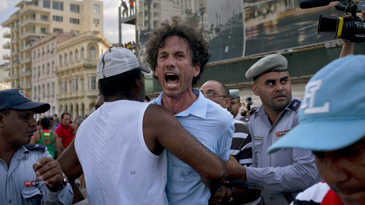 Cuban police detain a gay rights activist taking part in an unauthorized march in Havana, Cuba, Saturday, May 11, 2019. The march was organized largely using Cuba's new mobile internet, with gay-rights activists and groups of friends calling for a march over Facebook and WhatsApp after the government-run gay rights organization canceled a Saturday march.