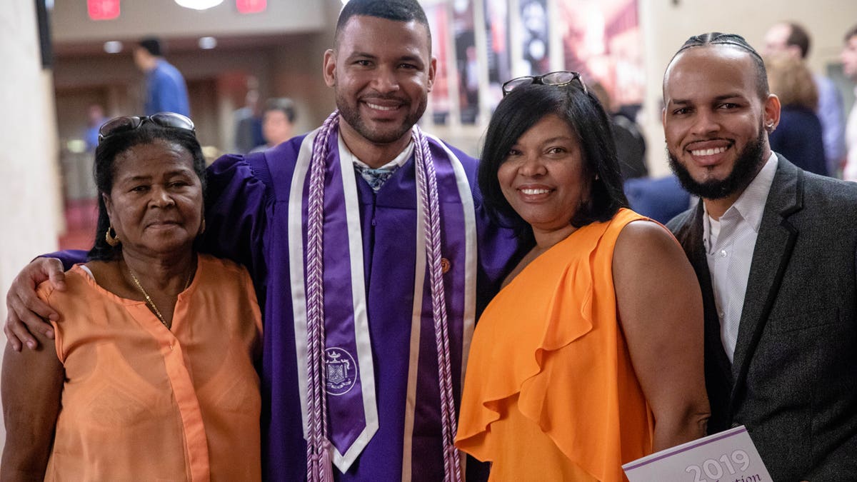 Frank Baez poses with family and friends after his graduation ceremony from the New York University Rory Meyers College of Nursing. 