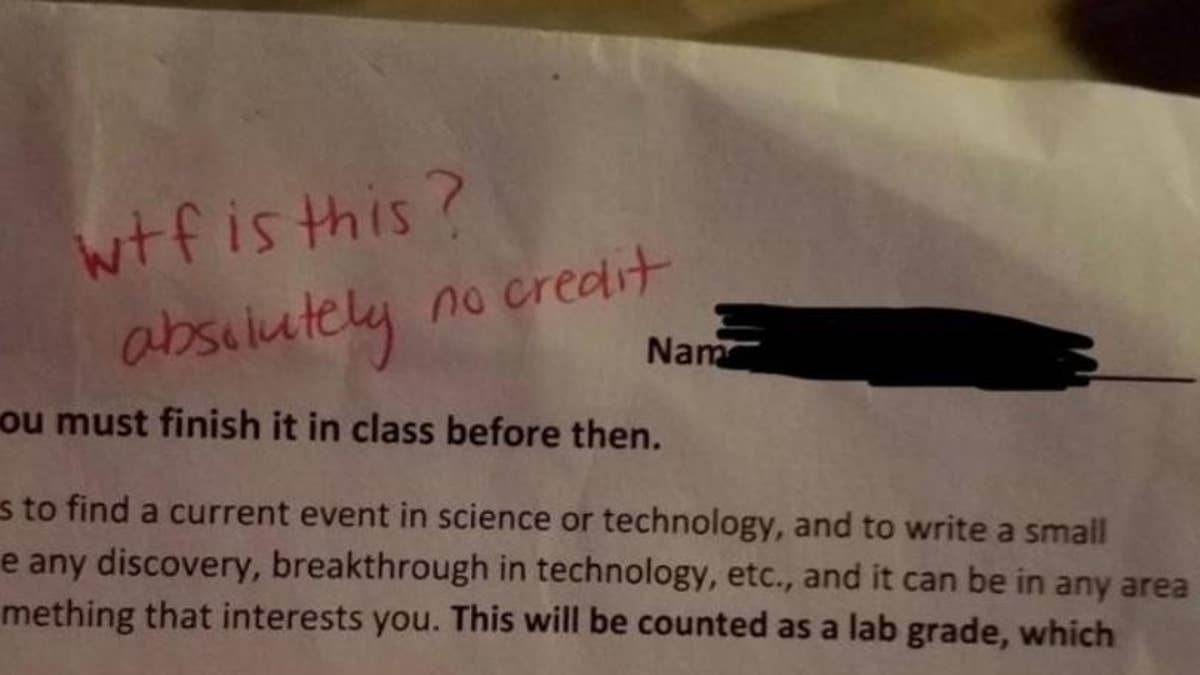 teacher writes note on students homework
