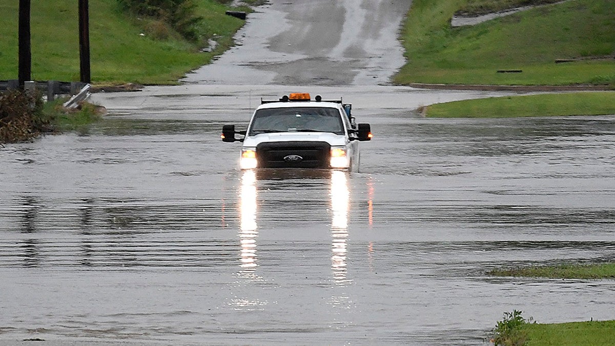 A pickup truck driving on a flooded street in Enid, Okla., on Monday. (Billy Hefton/The Enid News &amp; Eagle via AP)