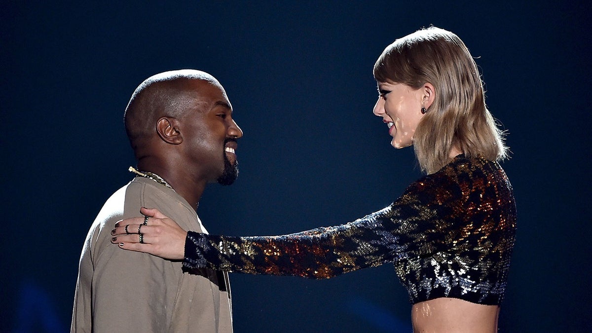 Recording artist Kanye West accepts the Video Vanguard Award from recording artist Taylor Swift onstage during the 2015 MTV Video Music Awards at Microsoft Theater on August 30, 2015 in Los Angeles. (Photo by Kevin Winter/MTV1415/Getty Images For MTV)