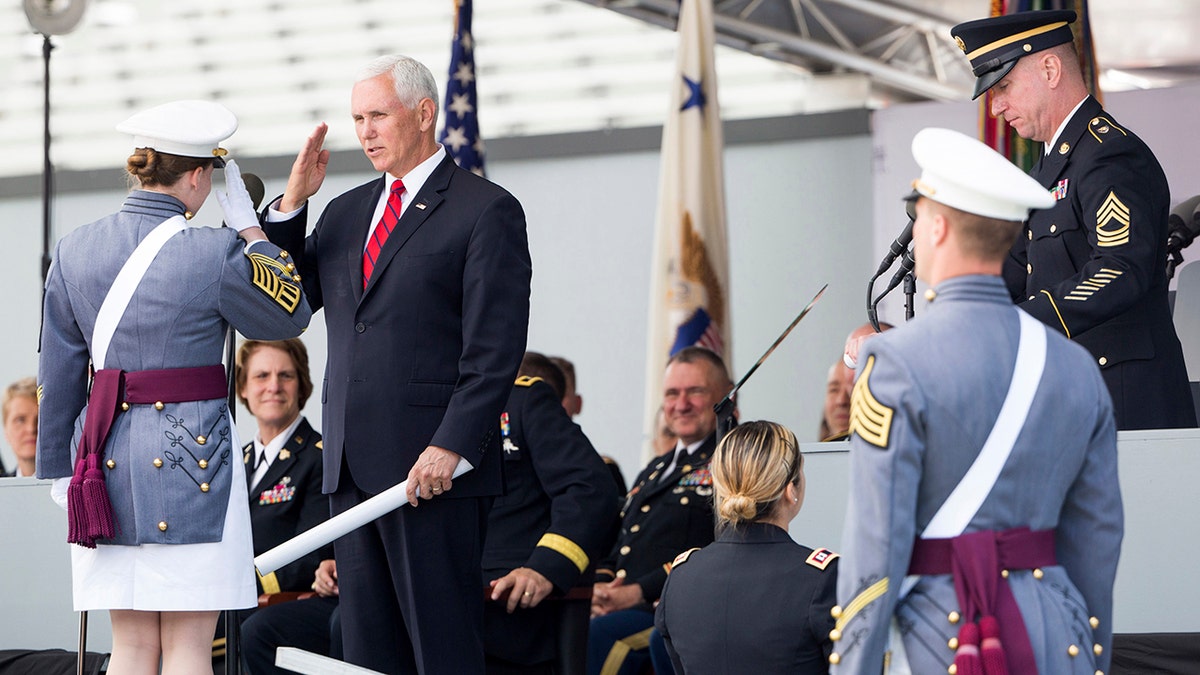 Vice President Mike Pence salutes a graduating cadet before handing a diploma to her during graduation ceremonies at the United States Military Academy, Saturday, May 25, 2019, in West Point, N.Y. (AP Photo/Julius Constantine Motal)