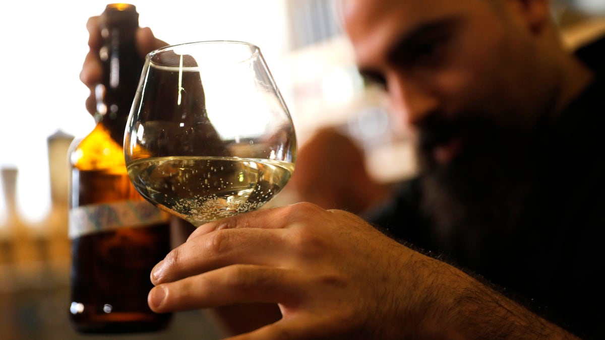 Craft brewer from Biratenu, the Jerusalem Beer Center, Shmuel Naky, right, pours beer during a press conference in Jerusalem, Wednesday, May 22, 2019. (AP Photo/Sebastian Scheiner)