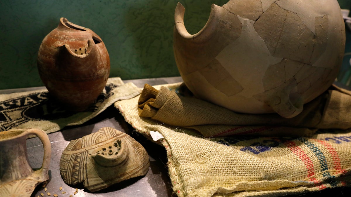 Ancient jars are on display during a press conference in Jerusalem, Wednesday, May 22, 2019. Israeli researchers celebrated Wednesday a long-brewing project of making beer and mead using yeasts extracted from ancient clay vessels -- some over 5,000 years old. (AP Photo/Sebastian Scheiner)