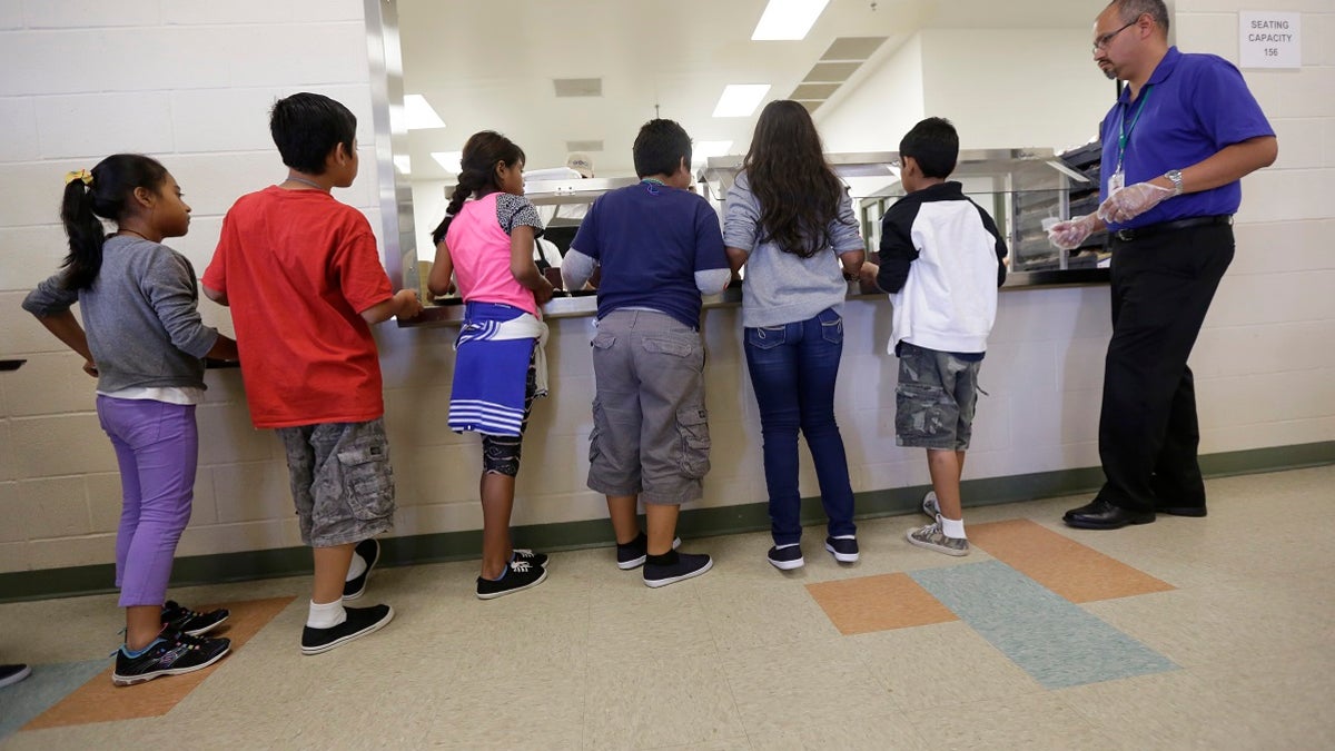 Detained immigrant children lining up in the cafeteria at the Karnes County Residential Center, a detention center for immigrant families, in Karnes City, Texas. (AP Photo/Eric Gay, File)