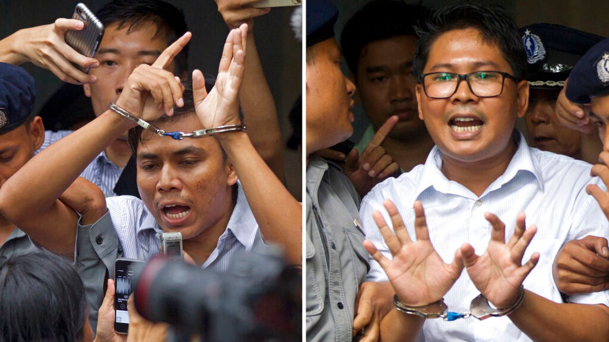 FILE: Reuters journalists Kyaw Soe Oo, left, and Wa Lone, are handcuffed as they are escorted by police out of a court in Yangon, Myanmar.