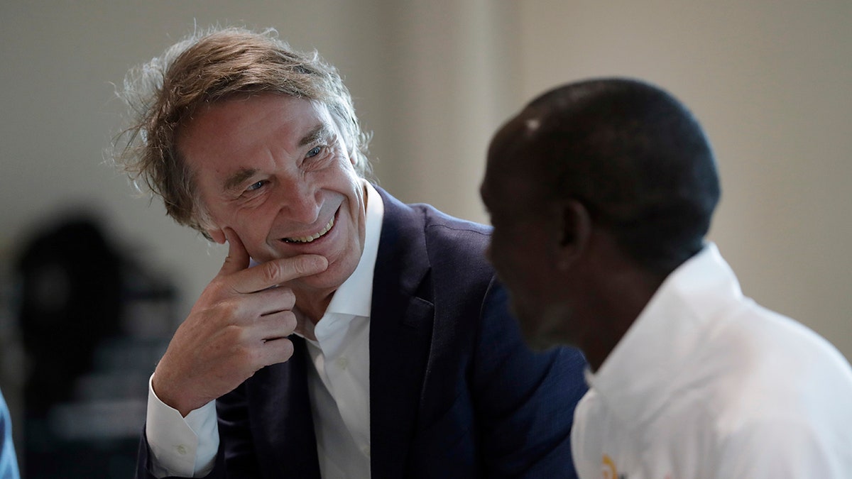 Marathon world record holder Kenya's Eliud Kipchoge and Britain's richest person Jim Ratcliffe, the founder of the INEOS Chemicals company. (AP Photo/Matt Dunham)