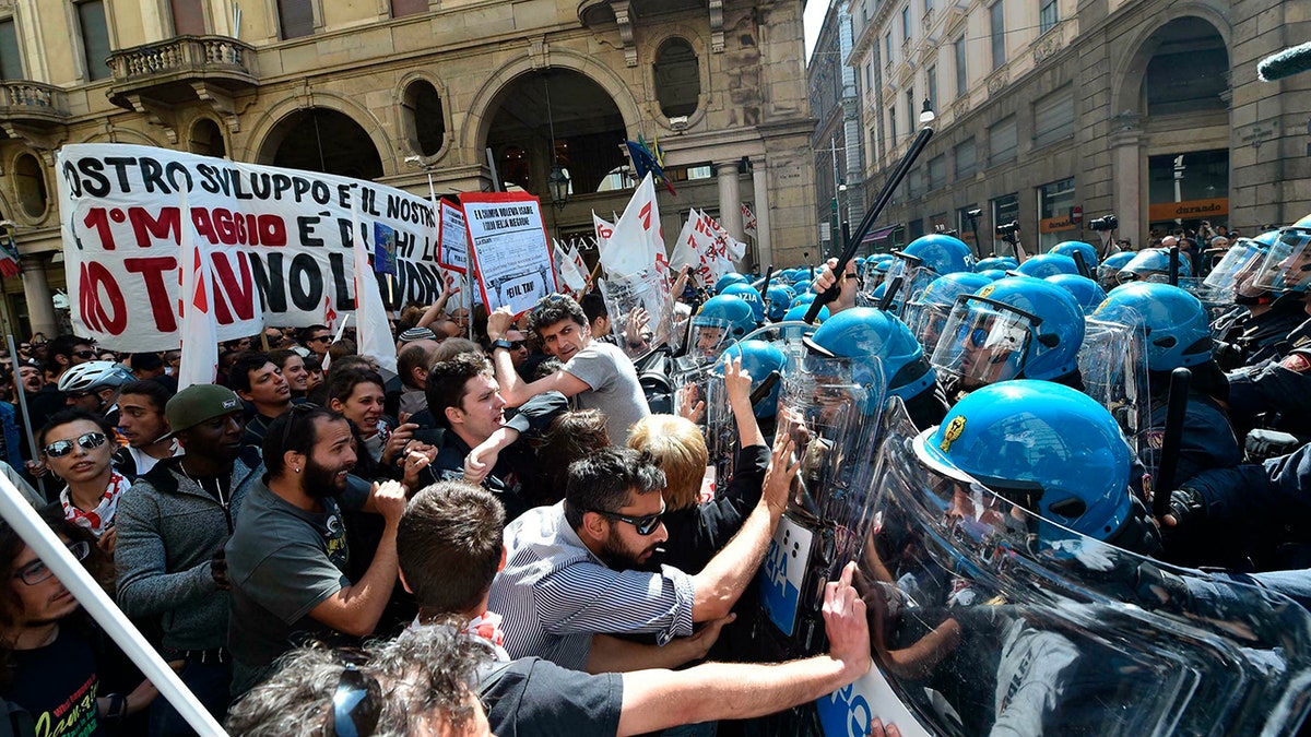 Demonstrators confront police officers as scuffles broke out during a May Day rally in Turin, Italy, Wednesday, May 1, 2019.