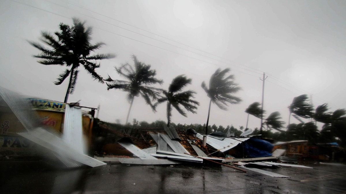 Street shops are seen collapsed due to gusty winds preceding the landfall of cyclone Fani on the outskirts of Puri, in the Indian state of Odisha. (AP Photo)