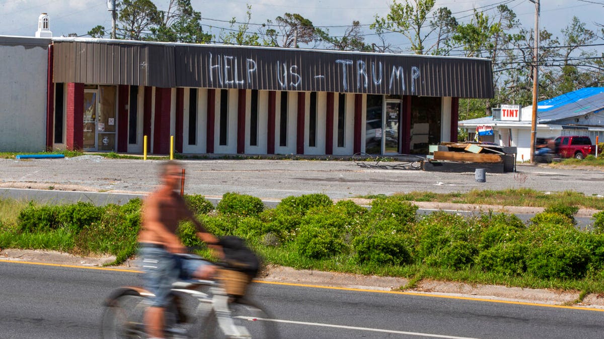 FILE: A cyclist rides by a building damaged by Hurricane Michael in Parker, Fla. Residents in these parts of the Florida Panhandle that were devastated by Hurricane Michael six months ago. (Associated Press)