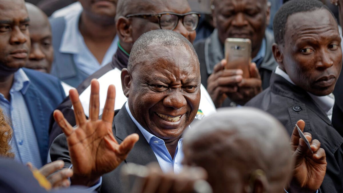 President Cyril Ramaphosa greets supporters after casting his vote at the Hitekani Primary School in Soweto, Johannesburg, South Africa Wednesday, May 8, 2019. 