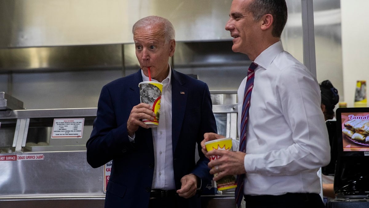 Democratic presidential candidate Joe Biden, left, visits a King Taco restaurant with Los Angeles Mayor Eric Garcetti on Wednesday. (Associated Press)