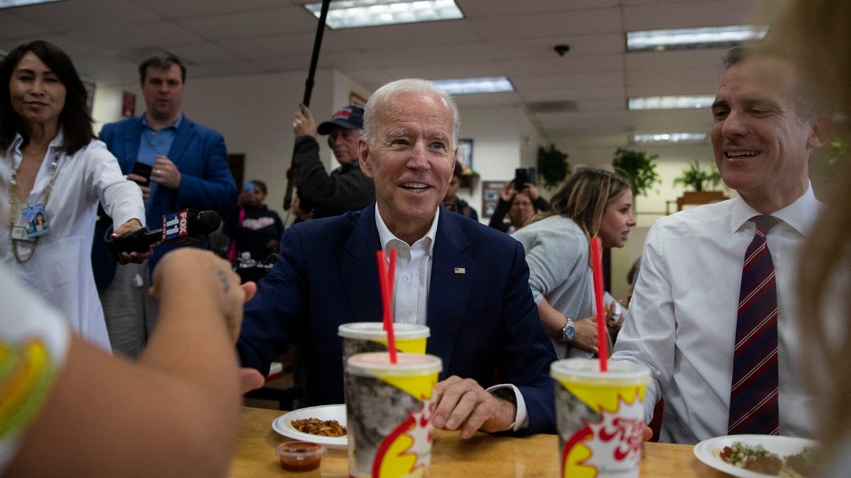 Democratic presidential candidate Joe Biden, center, talks to patrons he visits a King Taco restaurant with Los Angeles Mayor Eric Garcetti on Wednesday. (Associated Press)