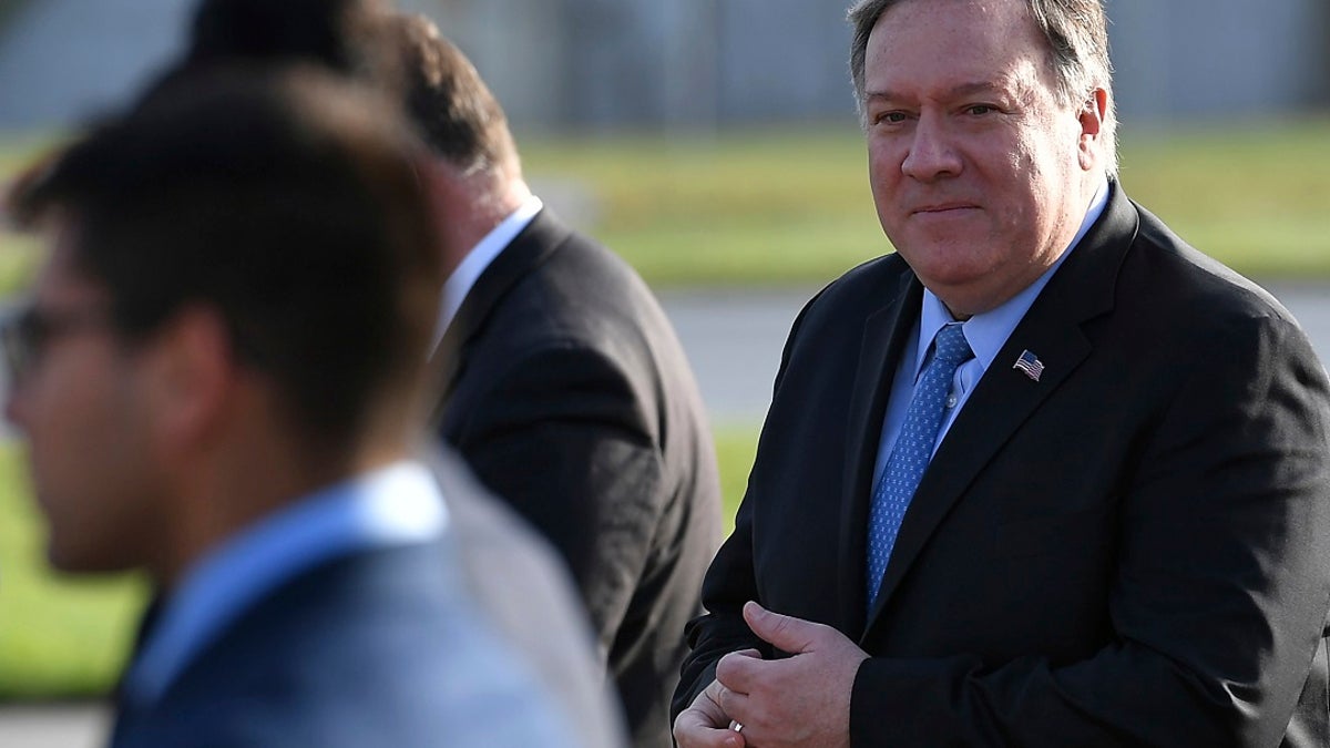 U.S. Secretary of State Mike Pompeo, right, walks to board a plane before departing from London Stansted Airport, north of London, Thursday, May 9, 2019. (Associated Press)