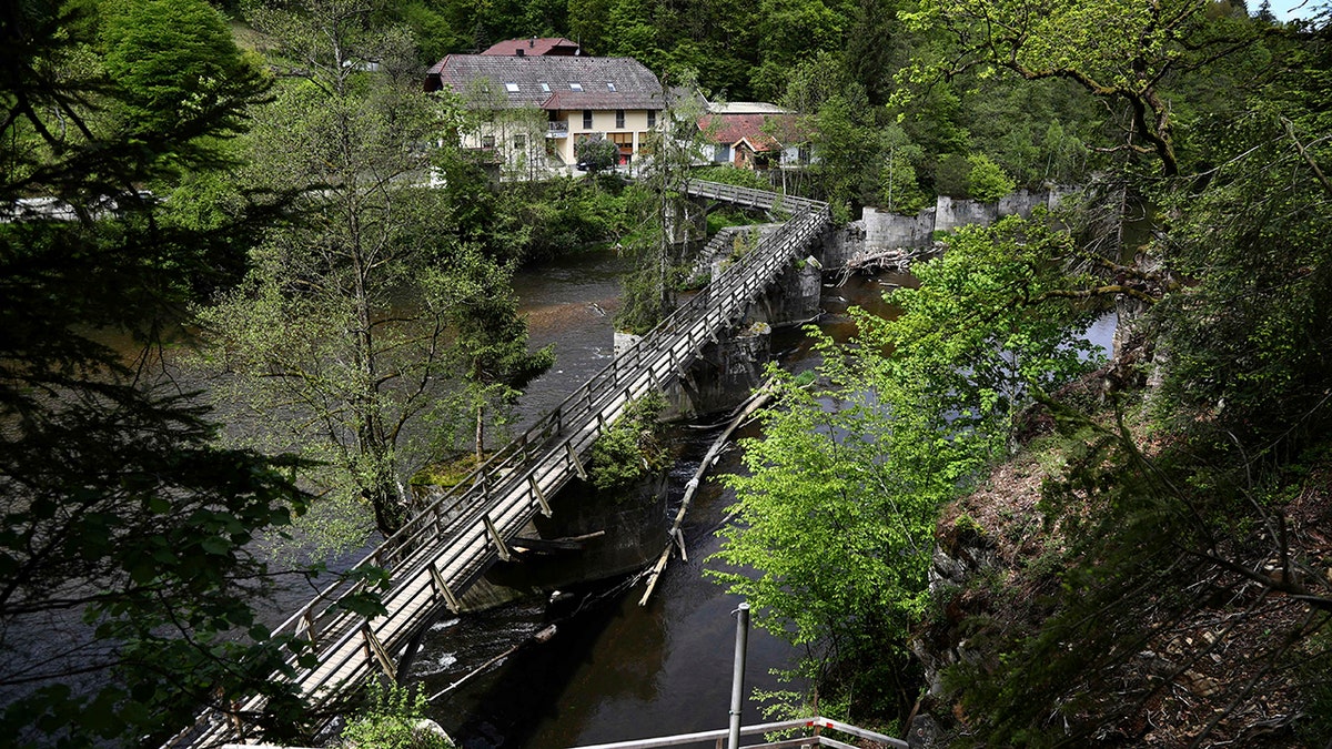 A guesthouse is pictured at the river 'Ilz' in Passau, Germany, Monday, May 13, 2019. Police investigating the mysterious death of three people whose bodies were found with crossbow bolts inside at the hotel in Bavaria on Saturday, May 11, 2019. (AP Photo/Matthias Schrader)