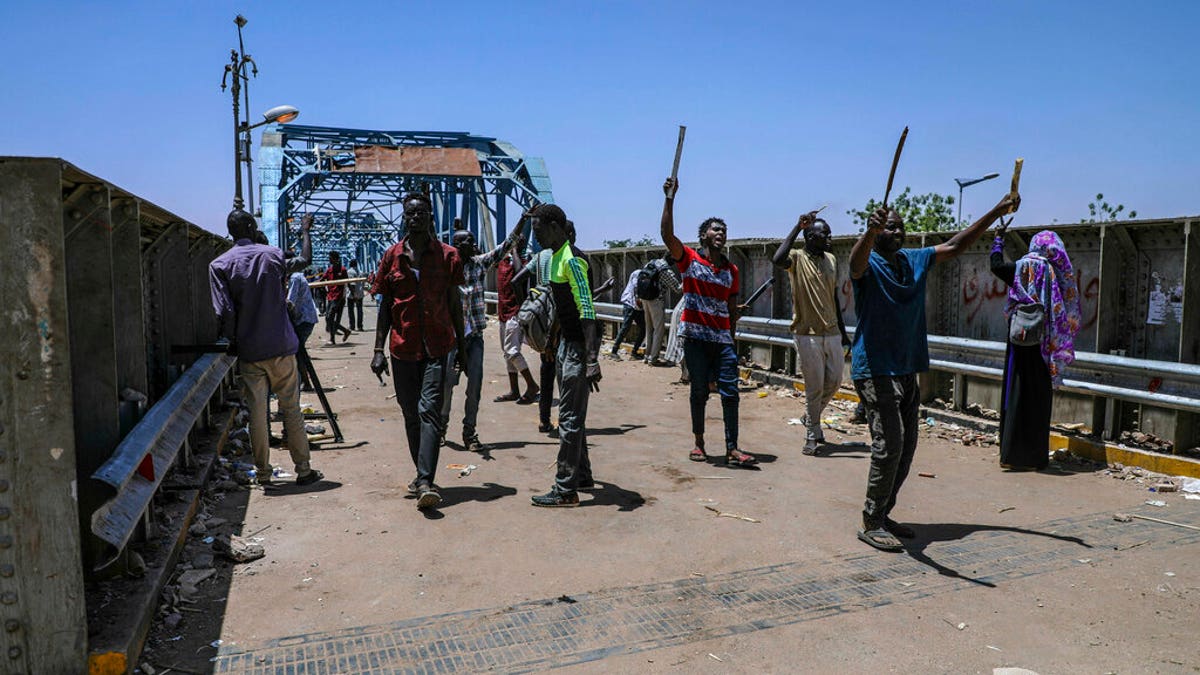 Protesters walk towards the sit-in protest outside the Sudanese military headquarters, in Khartoum, Sudan, Tuesday, May 14, 2019. 