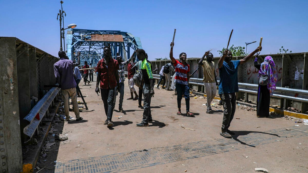 Protesters walk towards the sit-in protest outside the Sudanese military headquarters, in Khartoum, Sudan, Tuesday, May 14, 2019.