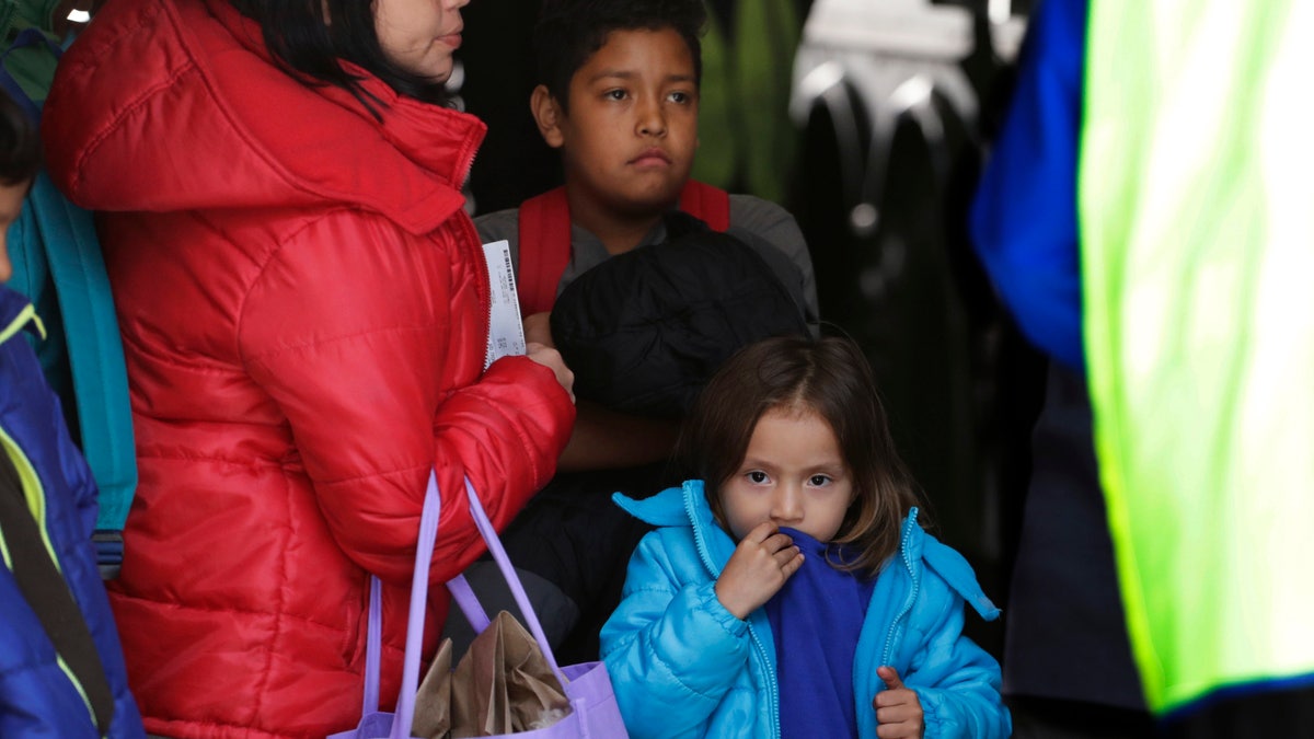 FILE - In this April 2, 2019, file photo, immigrants from Central America seeking asylum board a bus in San Antonio. The Trump administration has alerted two counties in Florida to prepare for an influx of immigrants at the border. The federal government is planning to transport more than 100 immigrants a week to Broward and Palm Beach counties, two predominately Democratic counties in Florida. The administration is providing no funding to house or feed them. (AP Photo/Eric Gay, File)