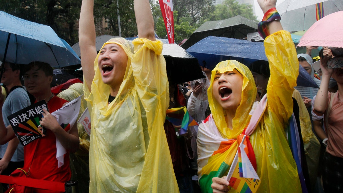 Same-sex marriage supporters cheer outside the Legislative Yuan in Taipei, Taiwan, on Friday, after Taiwan's legislature has passed a law allowing same-sex marriage in a first for Asia. (Associated Press)