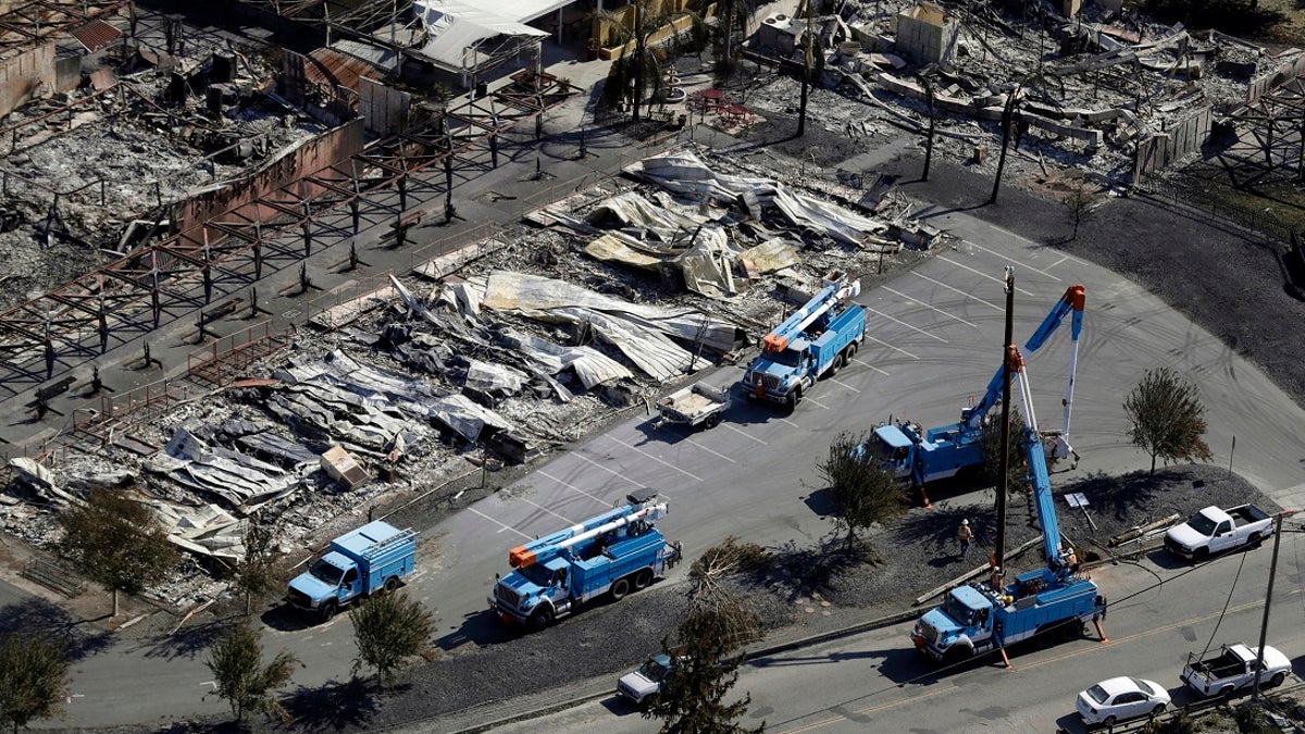 In 2017, PG&amp;E crews work on restoring power lines in a fire-ravaged neighborhood in an aerial view in the aftermath of a wildfire in Santa Rosa, Calif. (AP Photo/Marcio Jose Sanchez, File)