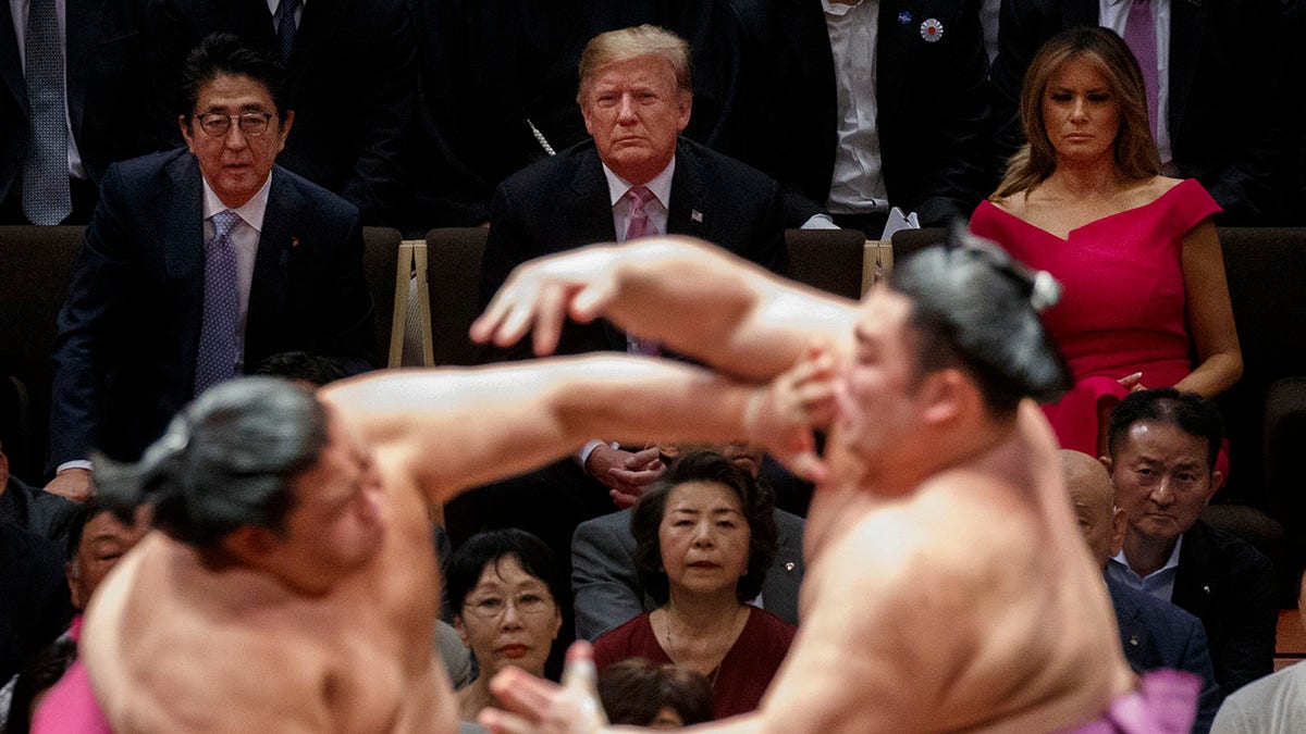 President Trump attends the Tokyo Grand Sumo Tournament with Japanese Prime Minister Shinzo Abe at Ryogoku Kokugikan Stadium, on Sunday, in Tokyo. First lady Melania Trump is at top right. (Associated Press)
