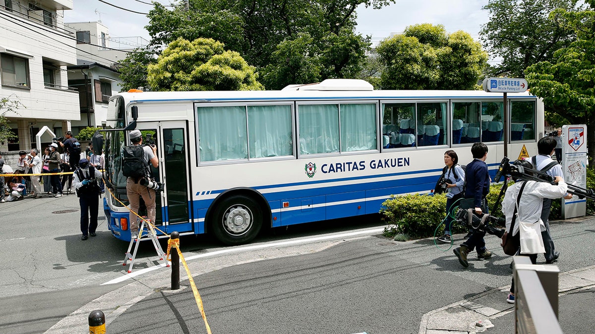 CARITAS Elementary School bus is seen near the scene where a man wielding a knife attacked commuters in Kawasaki, near Tokyo Tuesday, May 28, 2019.(Kyodo News via AP)
