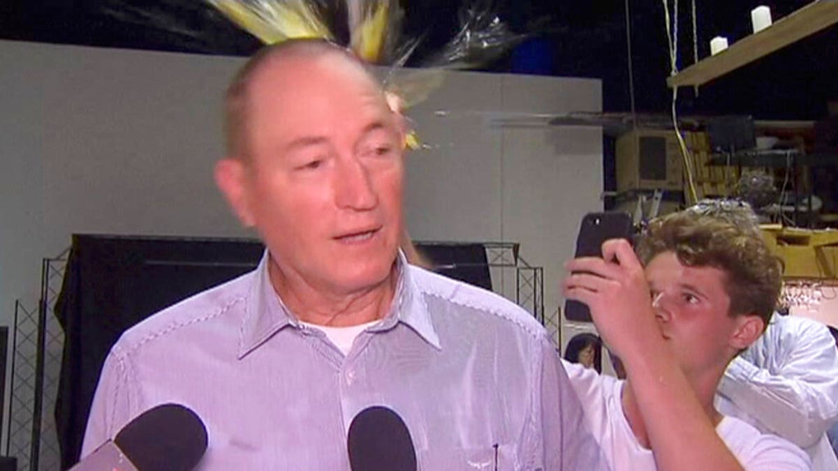 Will Connolly, pictured here, breaks an egg on the head of Senator Fraser Anning while he holds a press conference, in Melbourne. 
