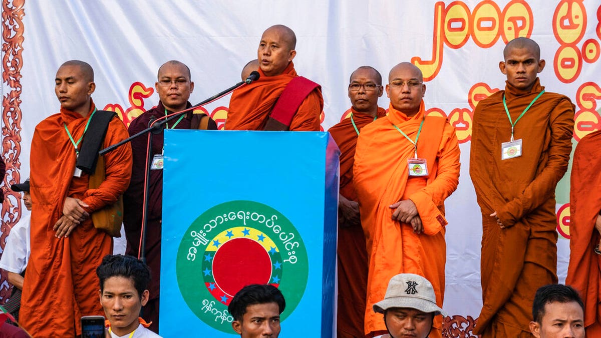 In this May 5, 2019, photo, Buddhist monk and anti-Muslim community leader Wirathu, center, speaks during a nationalist rally in Yangon, Myanmar.