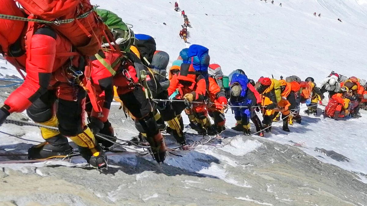 In this May 22, 2019 photo, a long queue of mountain climbers line a path on Mount Everest just below camp four, in Nepal. 