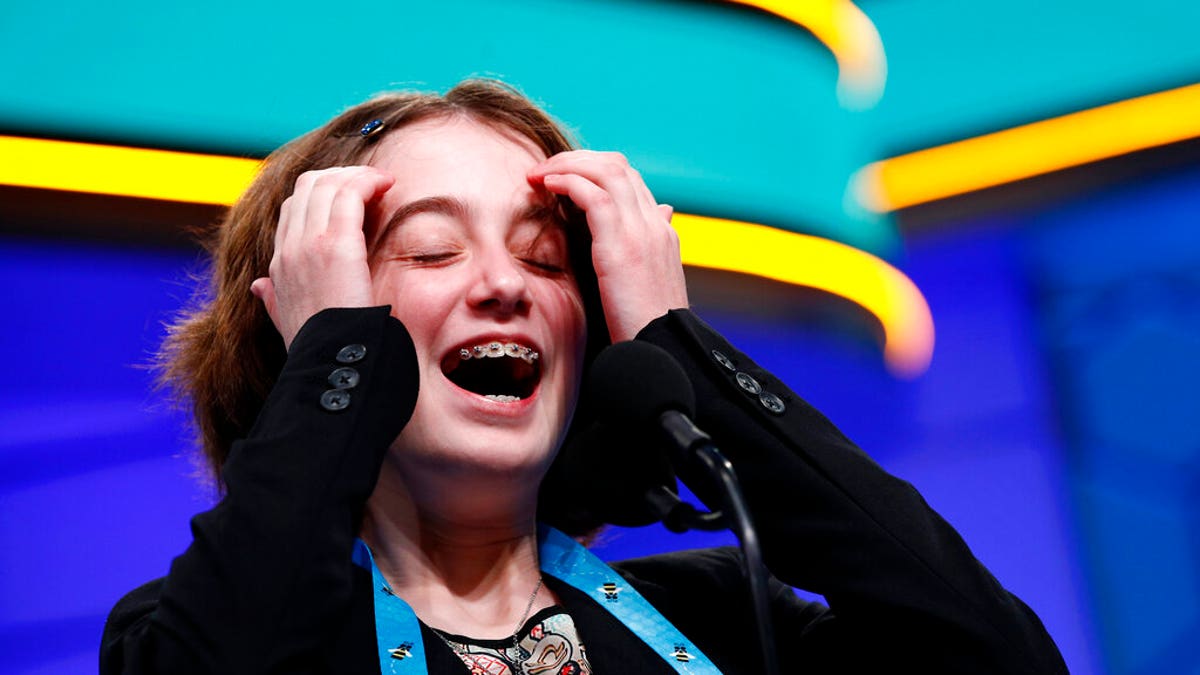 Colette Giezentanner, 12, of St. Louis, laughs as she competes in the finals of the Scripps National Spelling Bee, Thursday, May 30, 2019, in Oxon Hill, Md. (Associated Press)