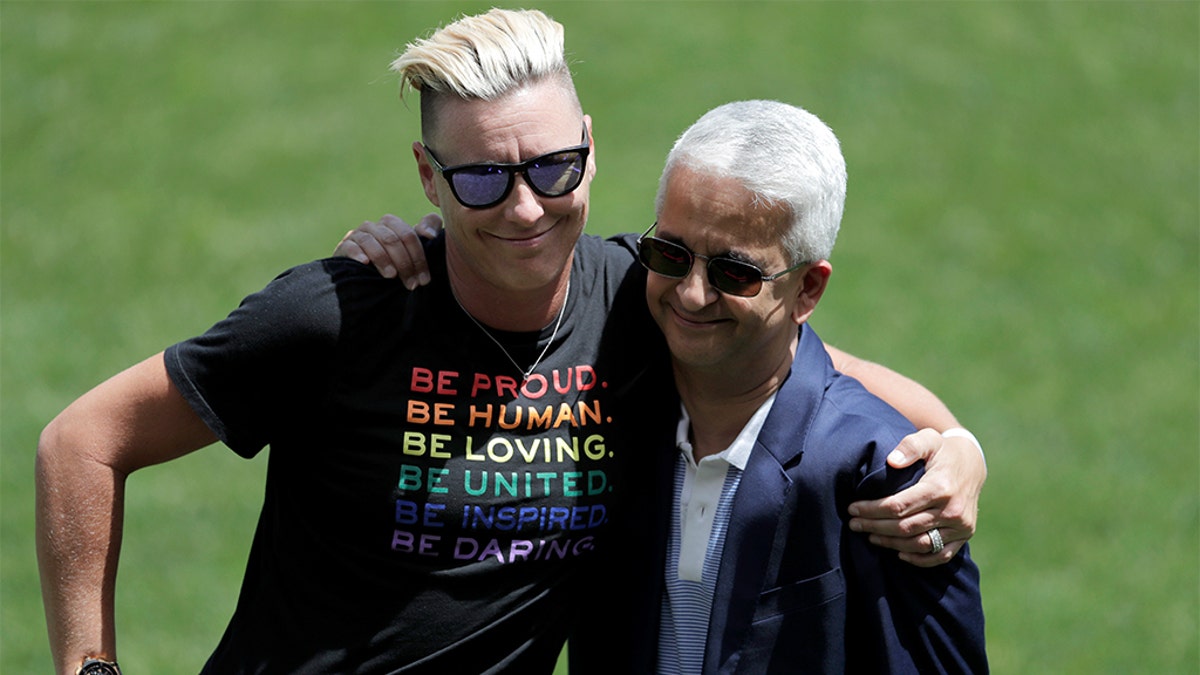 Abby Wambach, left, hugging Sunil Gulati, the former president of the United States Soccer Federation, during a celebration honoring the National Soccer Hall of Fame Class of 2019 at halftime of the match between the Unites States and Mexico on Sunday in Harrison, N.J. (AP Photo/Julio Cortez)