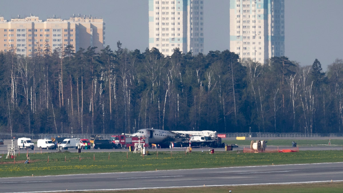 The Sukhoi SSJ100 aircraft of Aeroflot Airlines, center in the background, is seen after an emergency landing in Sheremetyevo airport outside Moscow, Russia, Monday, May 6, 2019.