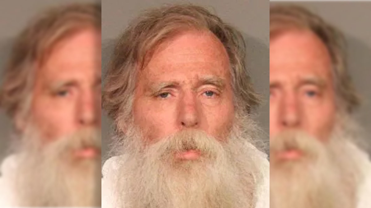 Anthony Brant Taylor, 64, was arrested in connection with the killing of a woman after he was discovered "covered in blood" lying in the middle of a street, according to officials.