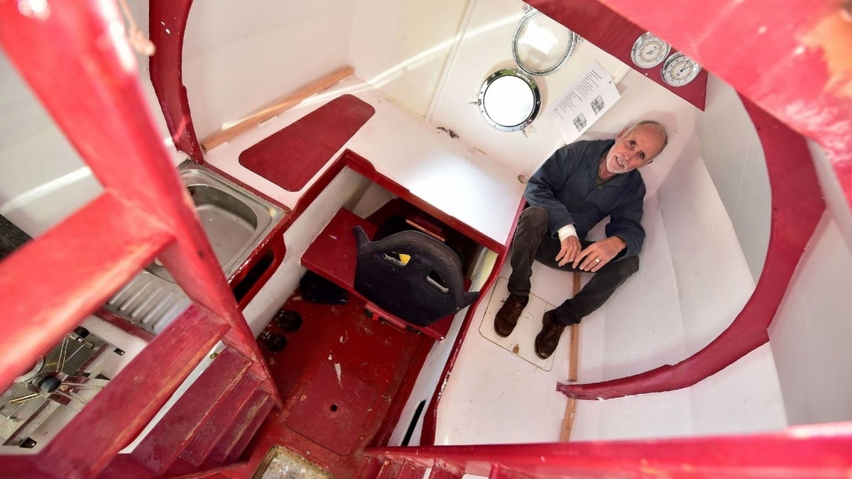 Jean-Jacques Savin shows the inside of the barrel that includes a bunk, kitchen and storage.