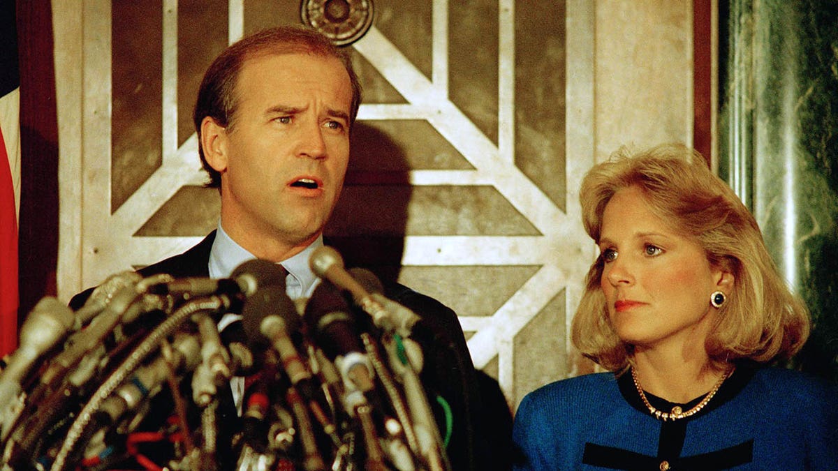 Sen. Joseph Biden Jr., D-Del., holds a news conference in Washington on Sept. 23, 1987, to announce he is withdrawing from the Democratic race for the presidential nomination. Biden's wife, Jill, listens to the announcement. (AP Photo/Ron Edmonds)