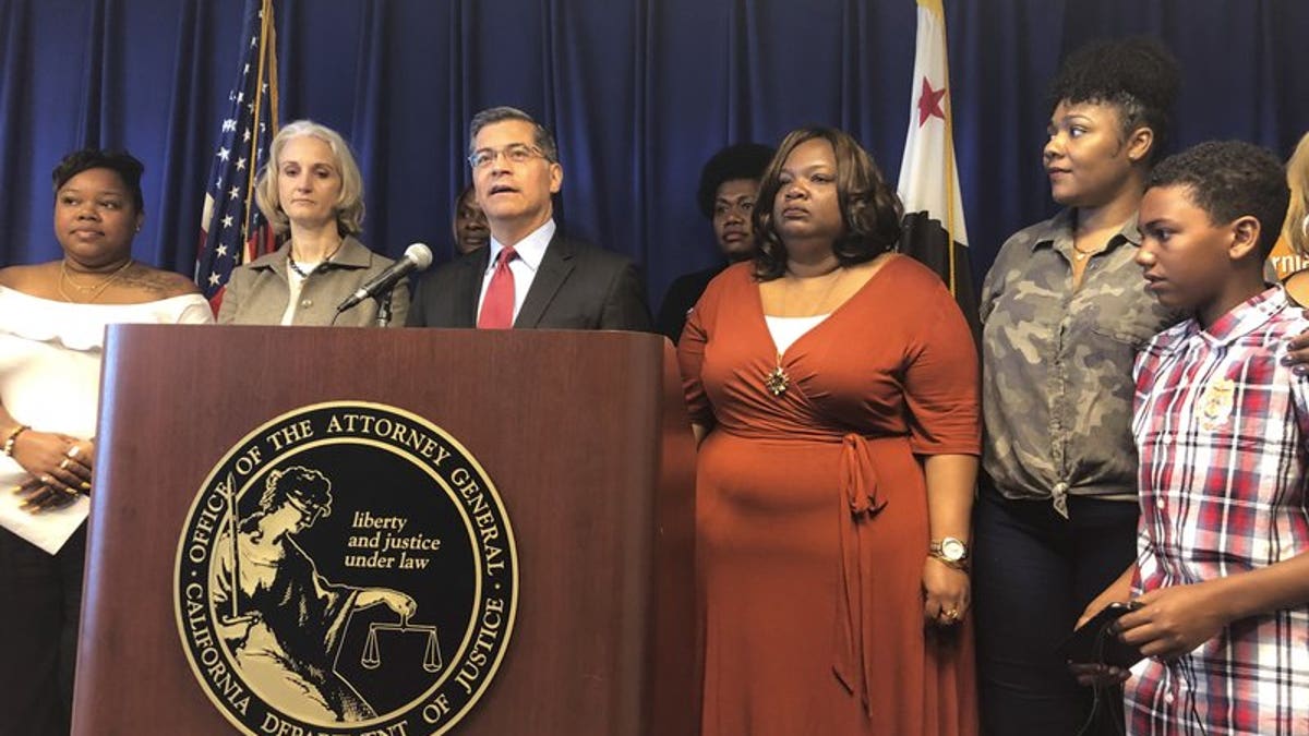 California Attorney General Xavier Becerra announces a lawsuit against the Trump Administration's new rule affecting home health care workers on Monday, May 13, 2019, in Sacramento, California.  (AP Photo/Adam Beam)