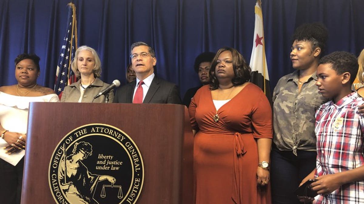 California Attorney General Xavier Becerra announces a lawsuit against the Trump Administration's new rule affecting home health care workers on Monday, May 13, 2019, in Sacramento, California. (AP Photo/Adam Beam)