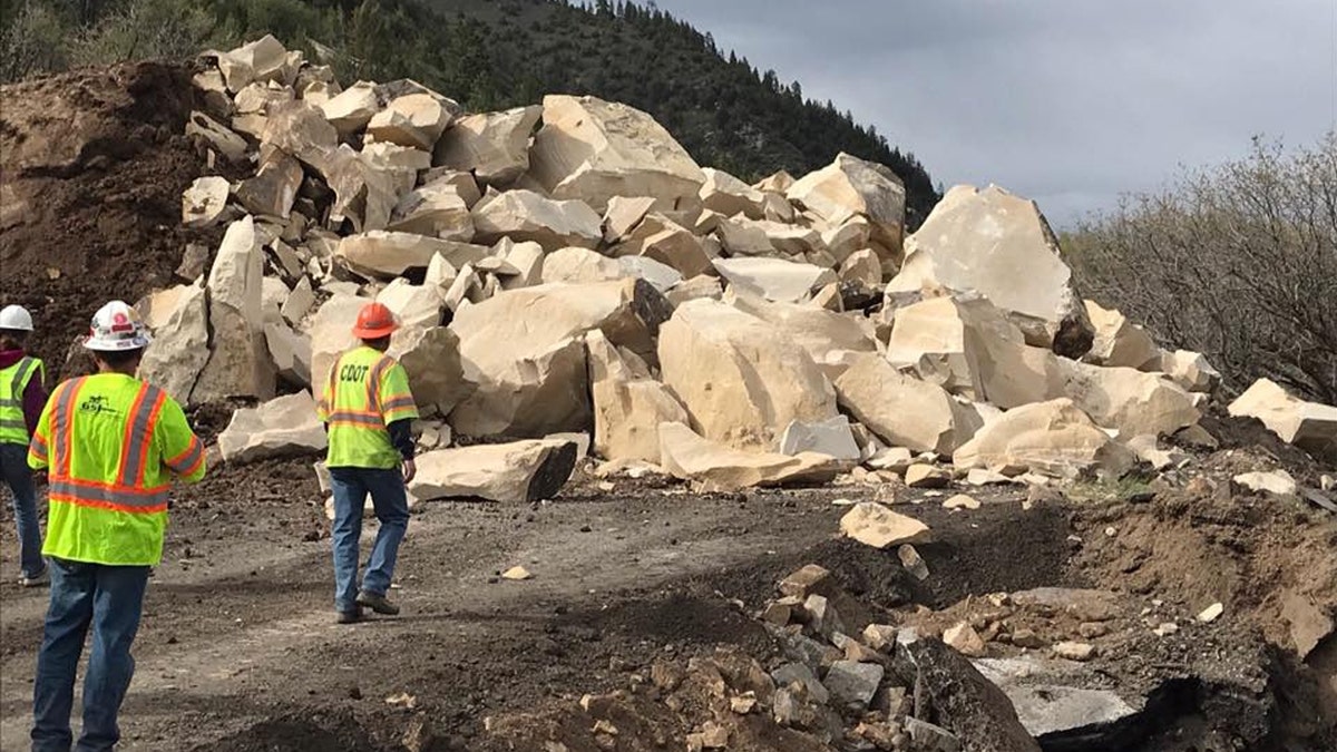 Rubble can be seen after a massive boulder was blasted into pieces after destroying a section of a highway in Colorado over the weekend.