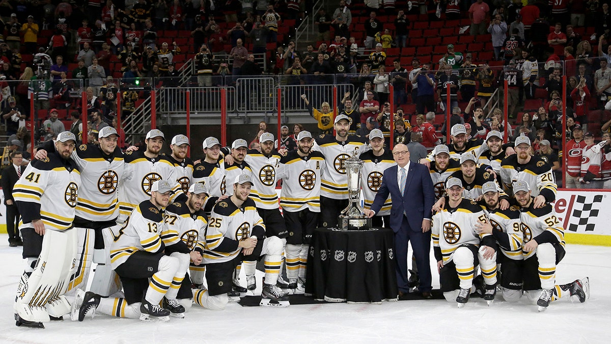 Boston Bruins players pose with the Prince of Wales trophy and Bill Daly, deputy commissioner of the National Hockey League, following Game 4 of the NHL hockey Stanley Cup Eastern Conference finals against the Carolina Hurricanes in Raleigh, N.C., on Thursday. Boston won 4-0 to advance to the Stanley Cup Final. (Associated Press)